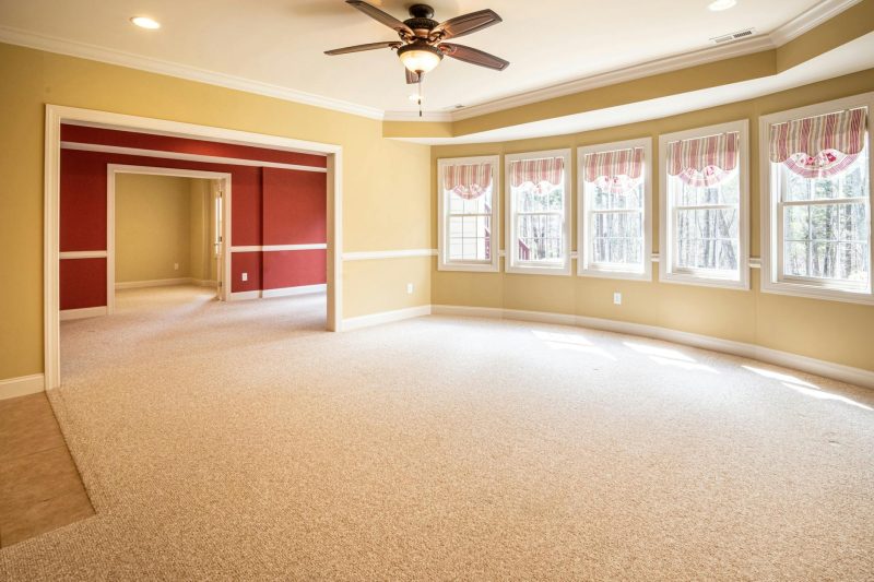 Home 135 Bright empty room with carpet and ceiling fan
