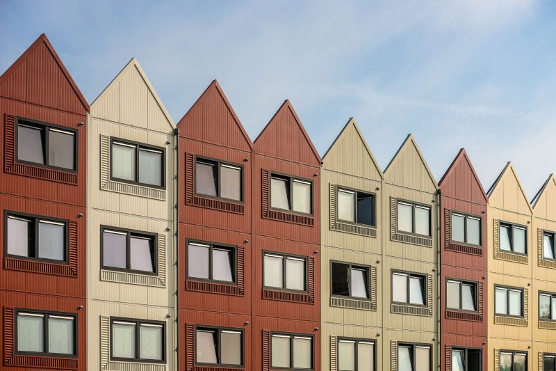 Home 143 A vibrant row of gableroofed residential buildings with meta 1782838821