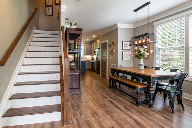 Home 141 Bright and inviting dining area features a wooden table stai 1784048529